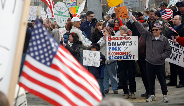 Hundreds of tea party tax protesters gather outside of the Federal building in Anchorage, Alaska on April 15, 2009. Websites such as Stormfront.org regularly encourage others to come out to tea party activities. (AP/Al Grillo)