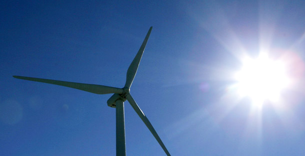 Sun reflects off a wind turbine in Peetz, CO. Projects to generate energy from wind, solar, geothermal, and biomass can invigorate rural economies by generating good-paying jobs that support families. (AP/Ed Andrieski)