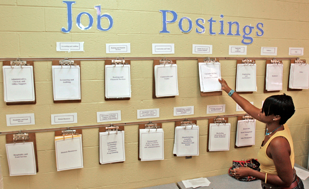 Maureen Sanders looks for postings at the Employment Connection in Parma, Ohio. Sanders, currently unemployed, is a recent graduate and is looking for a job as a dental assistant. (AP/Tony Dejak)