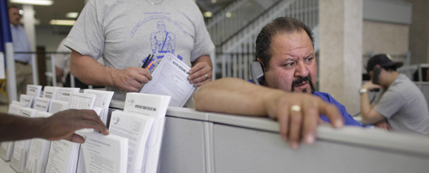 Jorge Deleon files an unemployment insurance claim over the phone at a Nevada Jobconnect Career Center in Las Vegas. Unemployment has gone up since last year, workers are staying unemployed longer, and food stamp requests are on the rise, which could all push poverty rates higher. (AP/Jae C. Hong)