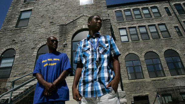 Richard Cherry Jr., right, 15, departs Boys' Latin School of Philadelphia with his father, Richard Cherry Sr, in Philadelphia on July 15, 2008. The new policies, which the School District of Philadelphia plans to fully implement by next year, include eliminating seniority from hiring decisions and revising the teacher evaluation system. (AP/Jacqueline Larma)