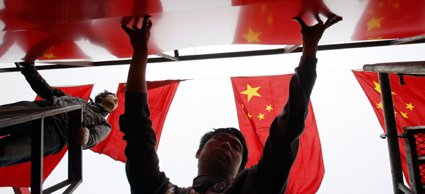 Chinese workers prepare decorations ahead of the 60th National Day celebrations in Beijing, China. (AP/Ng Han Guan)