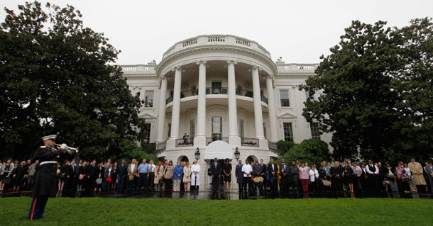 President Barack Obama and first lady Michelle Obama stand with White House staff members as they participate in a moment of silence marking the eighth anniversary of the 9/11 attacks. The counterterrorism successes of President Obama’s first months in office should put to rest the claim that nonmilitary strategies endanger U.S. national security. (AP /Charles Dharapak)