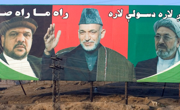 An election poster in Kabul, Afghanistan features first vice president Mohammad Qasim Fahim, Afghanistan president Hamid Karzai, and second vice president Mohammad Karim Khalili. (AP/Manish Swarup)