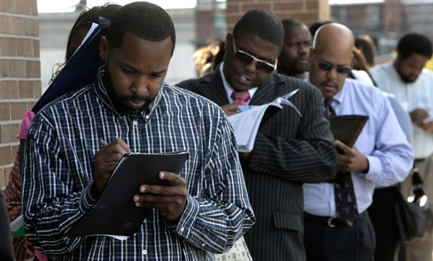 Jamal Randle, from left, Loren Cowling, and Dave Jackson fill out applications for positions at a new bar and restaurant in Detroit on September 25, 2009. In September 1982, the unemployment rate broke 10 percent, reached 10.8 percent December and remained above 10 percent for the first half of 1983. (AP/Paul Sancya)