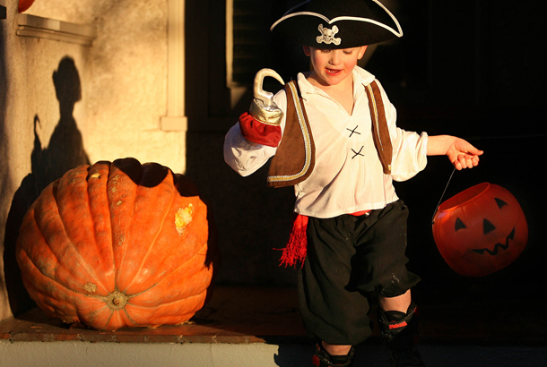 Dressed up as a pirate, Vance VomBaur leaves the doorstep of a house while trick or treating in a Laramie, Wyoming neighborhood. (AP/Andy Carpenean)
