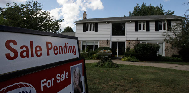 A home with "Sale Pending" sign rests on the front lawn in Beachwood, Ohio, on August 21, 2009. A flood of foreclosures in hundreds of communities around the country is dragging down home prices, devastating neighborhoods, and causing enormous drag on the economy that can potentially overwhelm the recovery. (AP /Tony Dejak)