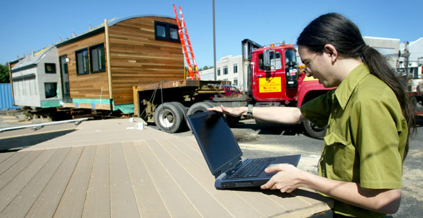 A University of Maryland graduate student monitors the progress of a solar house at College Park, MD. Twenty international teams of college students are convening on the National Mall this week to see who can design and operate the most attractive and energy-efficient solar-powered house. (AP/Matt Houston)