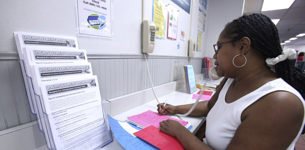 A woman checks her unemployment insurance over the phone at the California Employment Development Department office in Sacramento, CA. According to estimates from the National Employment Law Project, up to 600,000 Americans will have exhausted benefits provided by the Recovery Act by the end of October. (AP/Rich Pedroncelli)