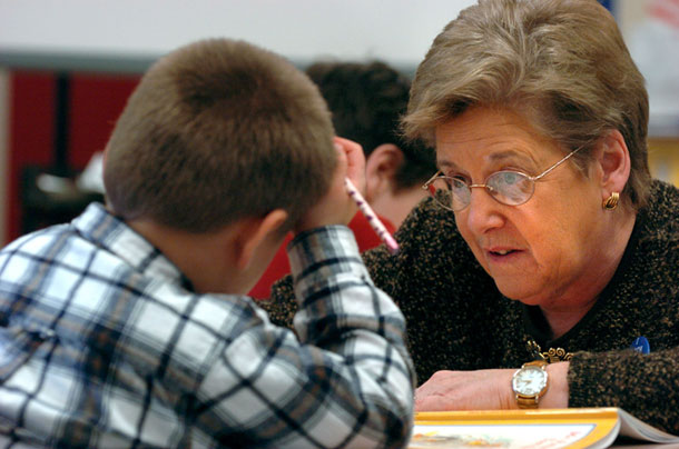 Sandy Gay, 2nd grade teacher at Princeton Primary School, helps a student in Princeton, WV. Gay is among the more 19,000 teachers and school officials who rely on 401(k)-style accounts for their retirement. (AP/Jon C. Hancock)