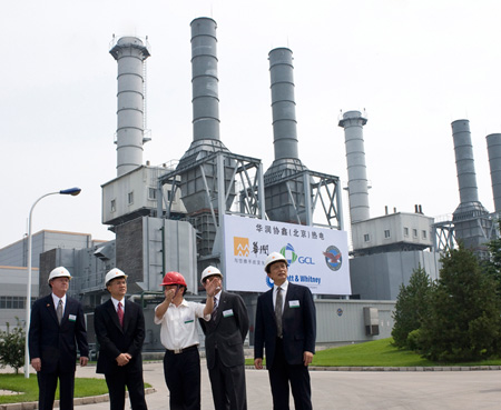 U.S. and Chinese officials stand before the China Resources Golden Concord Co-Generation Plant at the Beijing Development Area in Beijing earlier this year. (AP/Andy Wong)