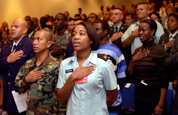 Approximately 70 immigrant soldiers in the U.S. military from 35 countries pledge their allegiance to the United States during a welcome home naturalization ceremony. (AP/John Amis)