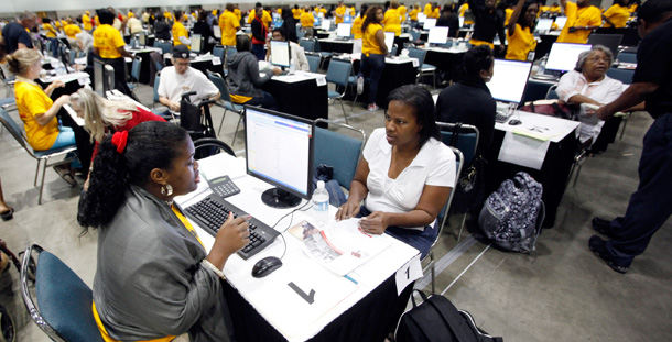 A homeowner gets help with restructuring her mortgage from a loan counselor at an event in Chicago. (AP/Damian Dovarganes)