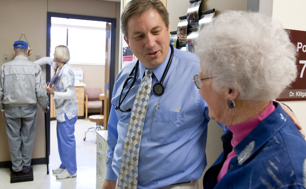 Primary care physician Dr. Don Klitgaard greets Muriel Bacon as her husband weighs in with a nurse, at the Myrtue Medical Center in Harlan, Iowa. (AP/Nati Harnik)