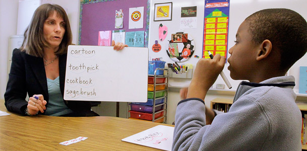 A resource reading and math teacher works with a fourth grade student at Ridgely Elementary School, a low-income school in Springfield, Illinois. (AP/Seth Perlman)