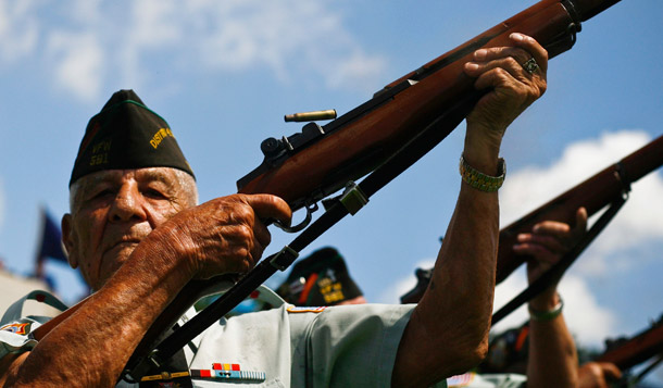 Veterans fire a round during a rifle salute on Memorial Day earlier this year. (AP/Michael Paulsen)