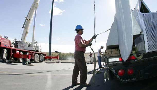 Workers unload a trailer filled with pieces of a windmill in Aurora, CO. The number of clean-energy jobs in the United States grew 9.1 percent between 1997 and 2008, while jobs overall only grew by 3.7 percent. (AP/David Zalubowski)