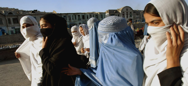 Afghan women walk along a popular shopping street in Kabul, Afghanistan. Human Rights Watch recently highlighted several major challenges faced by Afghan women, including attacks on women in public life, sexual violence, forced and child marriage, lack of access to justice, and lack of access to secondary education. (AP/Richard Vogel)