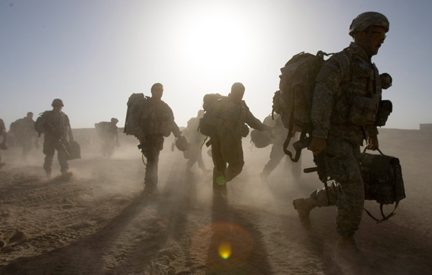 Troops from the U.S. 82nd Airborne head to a helicopter as they leave for a refit after two weeks at the forward operating base in Helmand Province, Afghanistan. (AP/Ryan Remiorz)