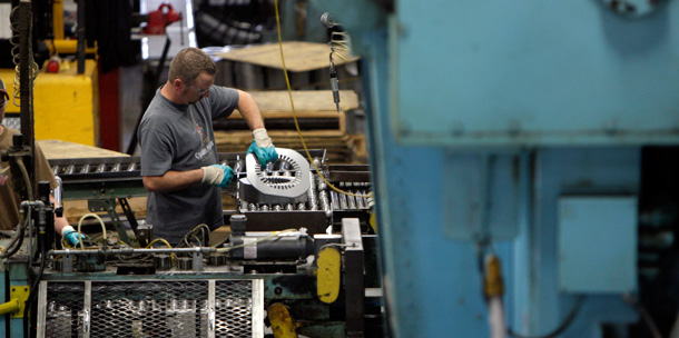 An employe works inside the Baldor Electric Company's factory in St. Louis, Missouri. Employment numbers show that the pace of job losses in manufacturing is slowing, and employers are adding more hours. (AP/Jeff Roberson)