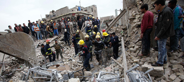 Fire fighters and rescuers search for survivors at the site of a bomb attack near the new Finance Ministry in Baghdad, Iraq on Tuesday, December 8, 2009. (AP/Hadi Mizban)