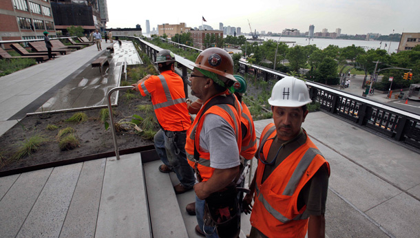 Construction workers stand on the abandoned elevated rail line in New York. (AP/Richard Drew)