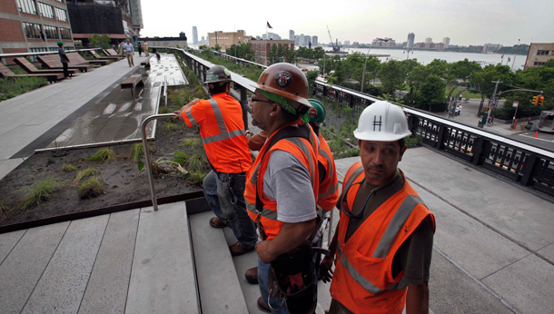 Construction workers stand on the abandoned elevated rail line in New York. (AP/Richard Drew)