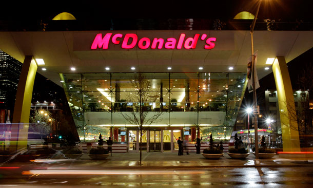 The lights from cars streak past the Rock N Roll McDonald's restaurant in Chicago on April 20, 2009. The New Jobs Tax Credit could give McDonalds a competitive advantage over its other competitors because it may be able to offer lower prices and spend more on advertising thanks to lower payroll costs. (AP/Charles Rex Arbogast)