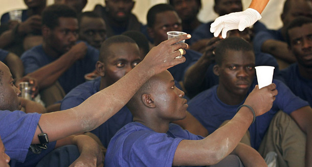 African immigrants are given drinks inside a hospital tent in Los Cristianos on the Canary island of Tenerife, Spain. The Spanish government set up operations in African countries to discourage migration to Spain, which could intensify with climate change's effects. (AP/Arturo Rodriguez)