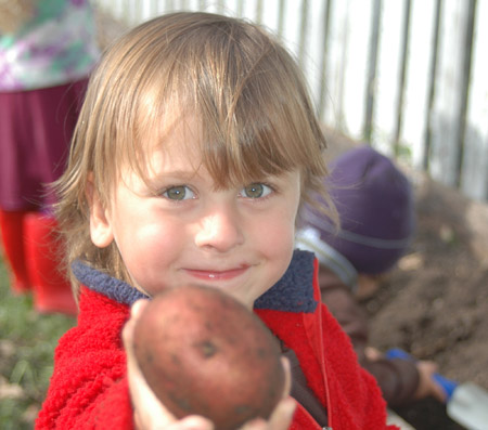 Rhys Marschke proudly holds up a potato he grew and harvested at the Rainbeau Ridge Farm. The farm educates children about the life of food. (Rainbeau Ridge)