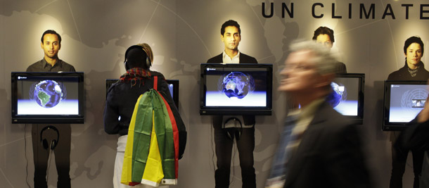 A representative from an African nongovernmental organization gets information from the interactive climate wall at the Bella Convention Center in Copenhagen, Denmark, on December 14, 2009. It's still unclear what the outcome of the talks will be, but the arrival of President Barack Obama and Chinese Prime Minister Wen Jiabao at the end of the week could be a decisive moment. (AP/Anja Niedringhaus)