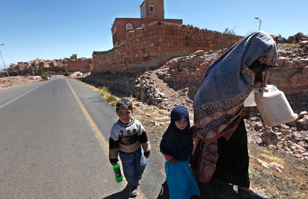 An elderly Yemeni and two children walk on the main road leading to the village of Kawkaban, north of the capital San'a, Yemen on January 10, 2010. Investing much needed U.S. assistance in good governance, anti-corruption efforts and economic reform alongside military assistance is our best chance at enhancing the long-term stability of Yemen and preventing radicalization. (AP/Nasser Nasser)