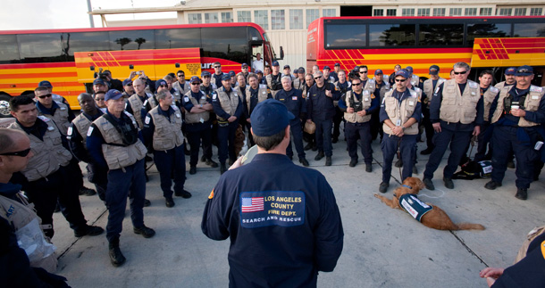 Members of the Los Angeles County Fire Department's Task Force 2 Search and Rescue team have a meeting to prepare to leave for Haiti to help in that country's devastating earthquake. (AP/Francis Specker)
