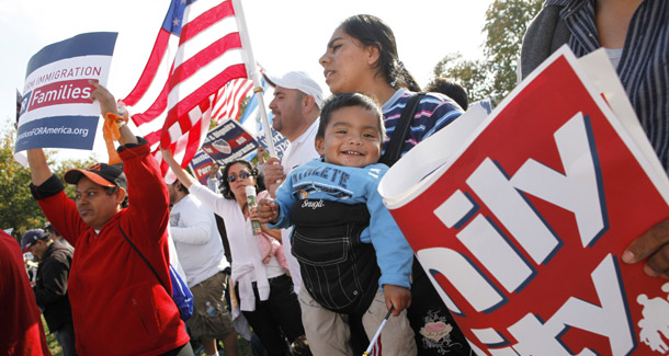 A woman holds her son at an immigration rally on October 13, 2009. Immigration reform has been, is now, and always will be a bipartisan issue, and we need real leadership. (AP/Jacquelyn Martin)