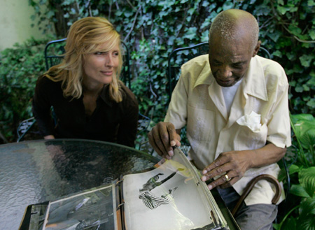 A woman listens as Frank Carter talks about his photo album. LGBT Americans like Frank are more likely to lack health insurance coverage and suffer from certain chronic conditions. (AP/Mary Altaffer)