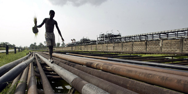 An unidentified youth walks on an oil pipeline in Idu Ogba, Nigeria. The United States imported 4 million barrels of oil a day—or 1.5 billion barrels per year—from “dangerous or unstable” countries in 2008 at a cost of about $150 billion. (AP/George Osodi)