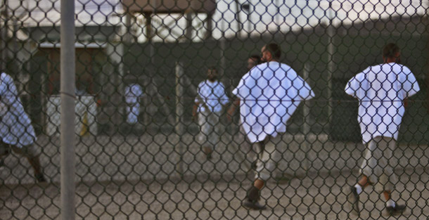 Guantanamo detainees jog at dusk inside the exercise yard at the Camp 4 detention facility on May 13, 2009. A number of conservatives who are opposed to closing the prison at Guantanamo Bay are attempting to exploit the “underpants bomber” to make their case. (AP/Brennan Linsley)
