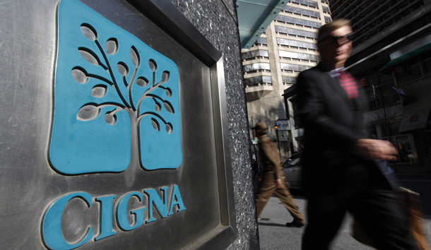 A pedestrian walks past the headquarters of the health insurer Cigna Corp. in Philadelphia. (AP/Matt Rourke)