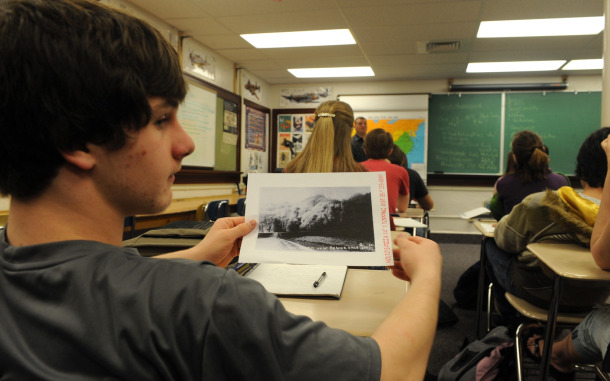Pocatello High School sophomore Doug Walker shows a fellow student a class handout during Jeb Harrison's economics class on March 16, 2009, in Pocatello, Idaho. More time alone is insufficient. Expanded learning time, in combination with a comprehensive reform strategy, is an invaluable component to turn around the most troubled, high-poverty schools and improve academic achievement among our neediest students. (AP/Bill Schaefer)