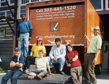 Workers stand outside the Rebuilding Center in Portland, OR. The center is the nation’s largest nonprofit for salvaged construction and remodeling materials and offers employees living wage positions with benefits. Portland created more than 20,000 green jobs in 2007 alone. (Flickr/<a href=