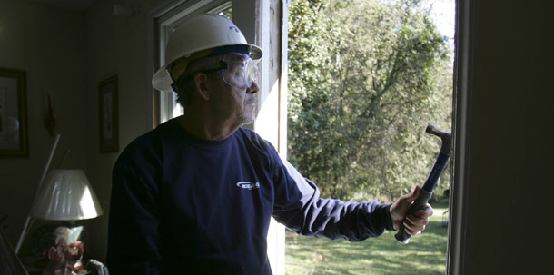 A worker helps install energy efficient windows in a West Columbia, SC, home. The HOME STAR program would reward consumers for installing energy efficient equipment in their homes and increase demand for the hard-hit construction industry. (AP/Mary Ann Chastain)