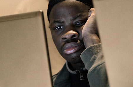 Reginald Murphey views online job listings while attending a job fair in Detroit. Far too many men, and especially African-American men, are disconnected from employment, but also from society and their families. (AP/Paul Sancya)