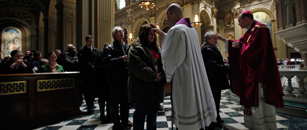 Rev. Philip Forlano and the Rev. Timothy C. Senior put ash on the foreheads of faithfuls during Ash Wednesday Mass at Cathedral Basilica of Saints Peter and Paul in Philadelphia. (AP/Matt Rourke)