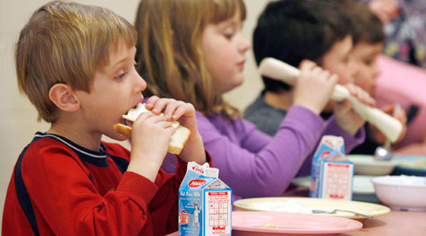 This February 3, 2010 photo shows students eating lunch at Sharon Elementary School in Sharon, VT. Child hunger in the world’s wealthiest nation is morally unacceptable, and it costs the U.S. economy at least $28 billion per year because poorly nourished children perform less well in school and require far more long-term health care spending. (AP/Toby Talbot)