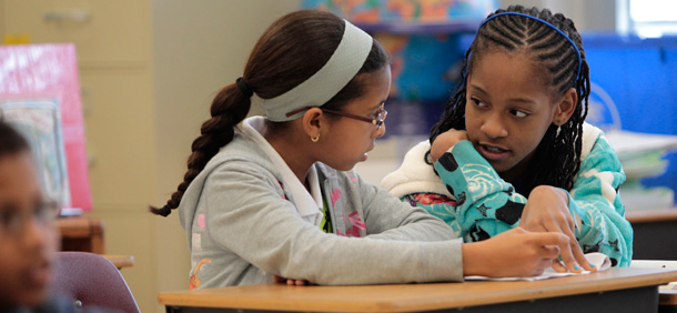 Madjany Mouscardy works with a student tutor on her match lesson at Silver Shores Elementary School in Mirimar, Florida. (AP/Hans Deryk)