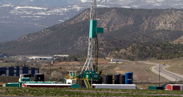 In this April 22, 2008 photo, a natural gas well pad sits in front of the Roan Plateau near the Colorado mountain community of Rifle. Hydraulic fracturing, also called “fracking” or “fracing,” is a widely used but somewhat controversial oil and gas drilling technique. (AP/David Zalubowski)