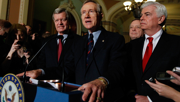 Senate Majority Leader Harry Reid answers questions outside of the Senate chambers on Capitol Hill after the Senate passed the health care reform bill. (AP/Mannul Balce Ceneta)