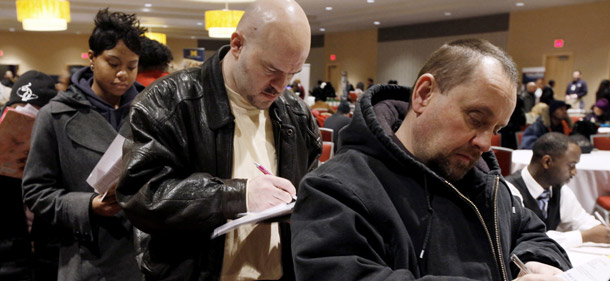 Unemployed workers fill out job applications at a jobs fair in Detroit. The unemployment rate held at 9.7 percent in February as employers shed fewer jobs than expected, but job creation should continue to be a top priority for Congress. (Center for American Progress)
