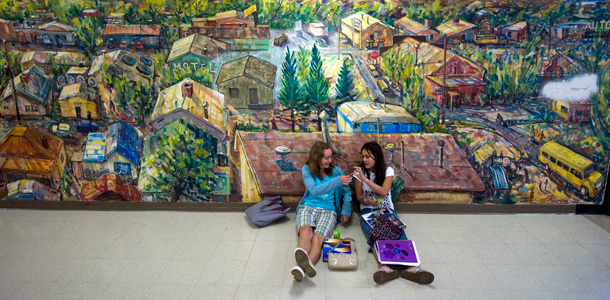 Students sit in front of a mural in Reserve, New Mexico. The mural is an homage to the town's timber industry, which has collapsed, leaving one-quarter of residents living below the federal poverty line. (AP/Chris Carlson)