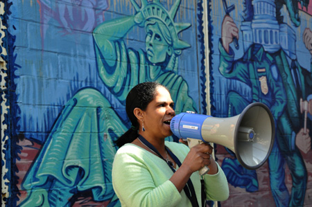 A member of community services organization Make The Road New York rehearses chants ahead of the march in Washington on Sunday. (AP/Diego Graglia)